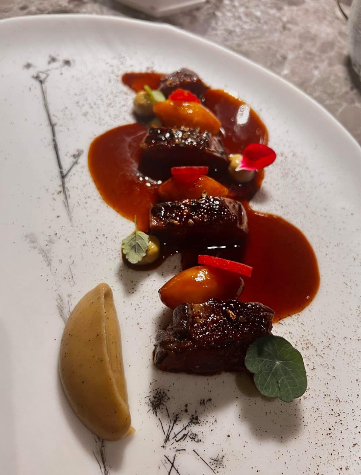 An artistically plated dish created by chef Altin Mero, showcasing his Mediterranean roots and international influences